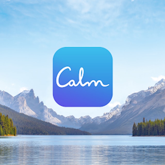 Image of a lake with trees and mountains in the background. The calm logo is in the middle of the image.